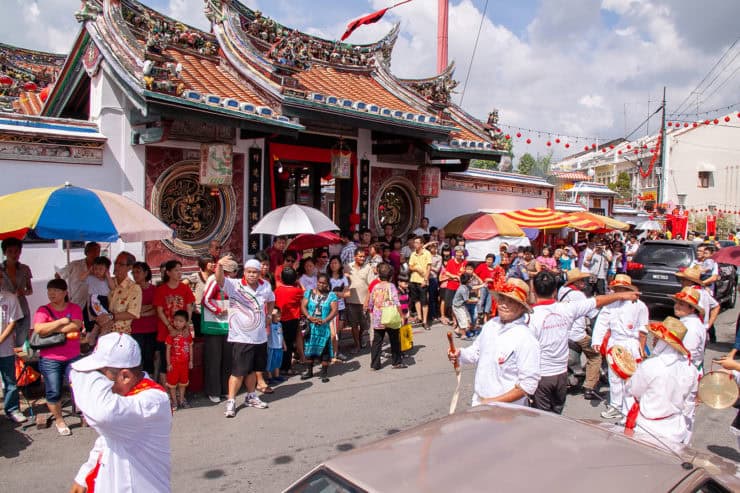 Kleurrijk geliefde Chinese tempel in Maleisië tijdens een feestelijke gebeurtenis met een street parade en enthousiaste menigte.