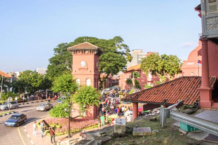 Kleurrijk straatbeeld met historische gebouwen, mensen en groen in het centrum van Kuala Lumpur, Maleisië, perfect voor reizigers die geïnteresseerd zijn in cultuur en architectuur.