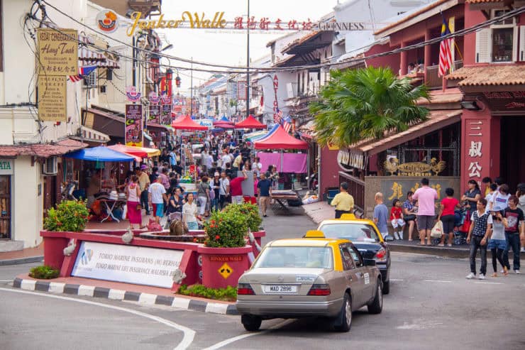 Kleurrijke straatmarkt in Chinatown, Kuala Lumpur, met lokale winkels, gezellige terrasjes, en bezoekers die genieten van de multiculturele sfeer en streetfood in Maleisië.